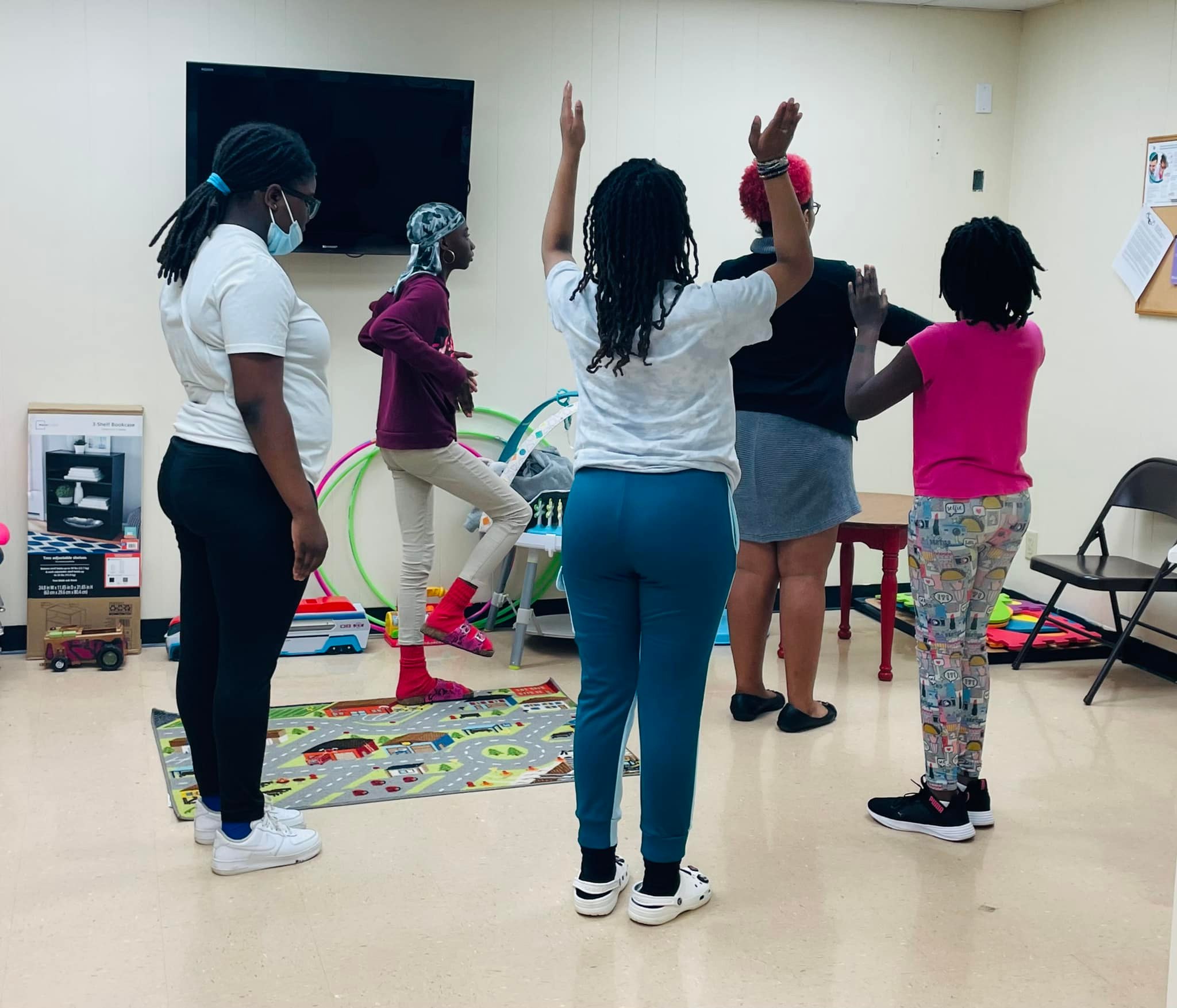 Young ladies learning a step routine